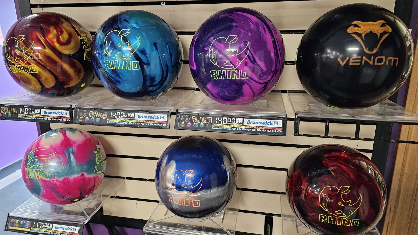 Brunswick Rhino, Twist and Venom bowling balls on the pro shop wall with prices