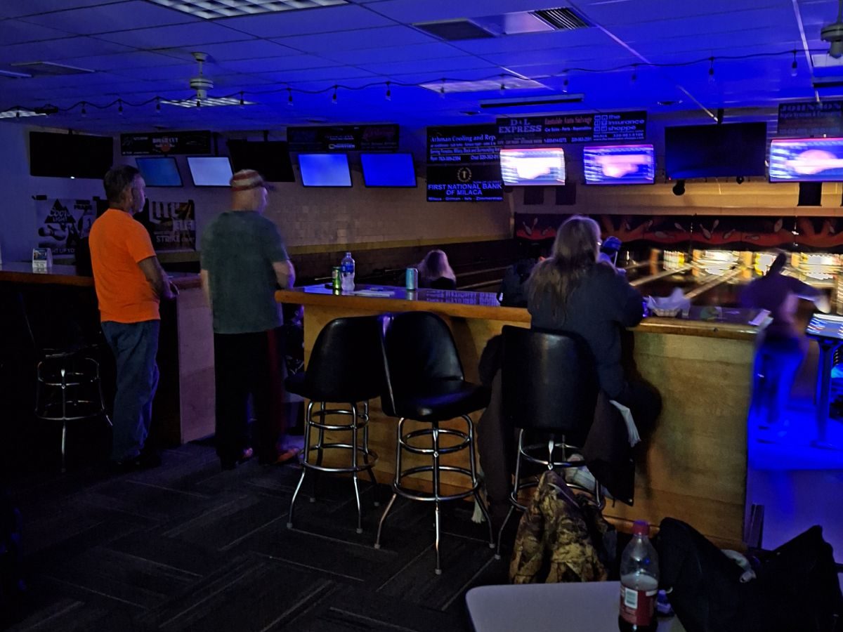 Bowlers at the bar rail watching the lanes on a Moonlight Jackpot night