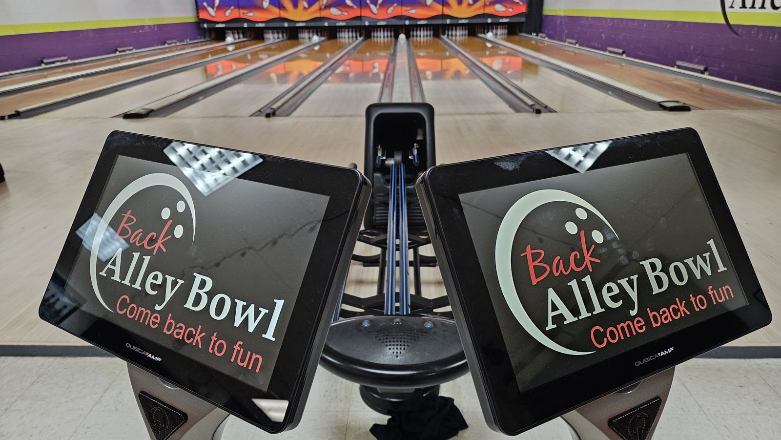 Two lane scoring screens showing the Back Alley Bowl logo, with the lanes behind them